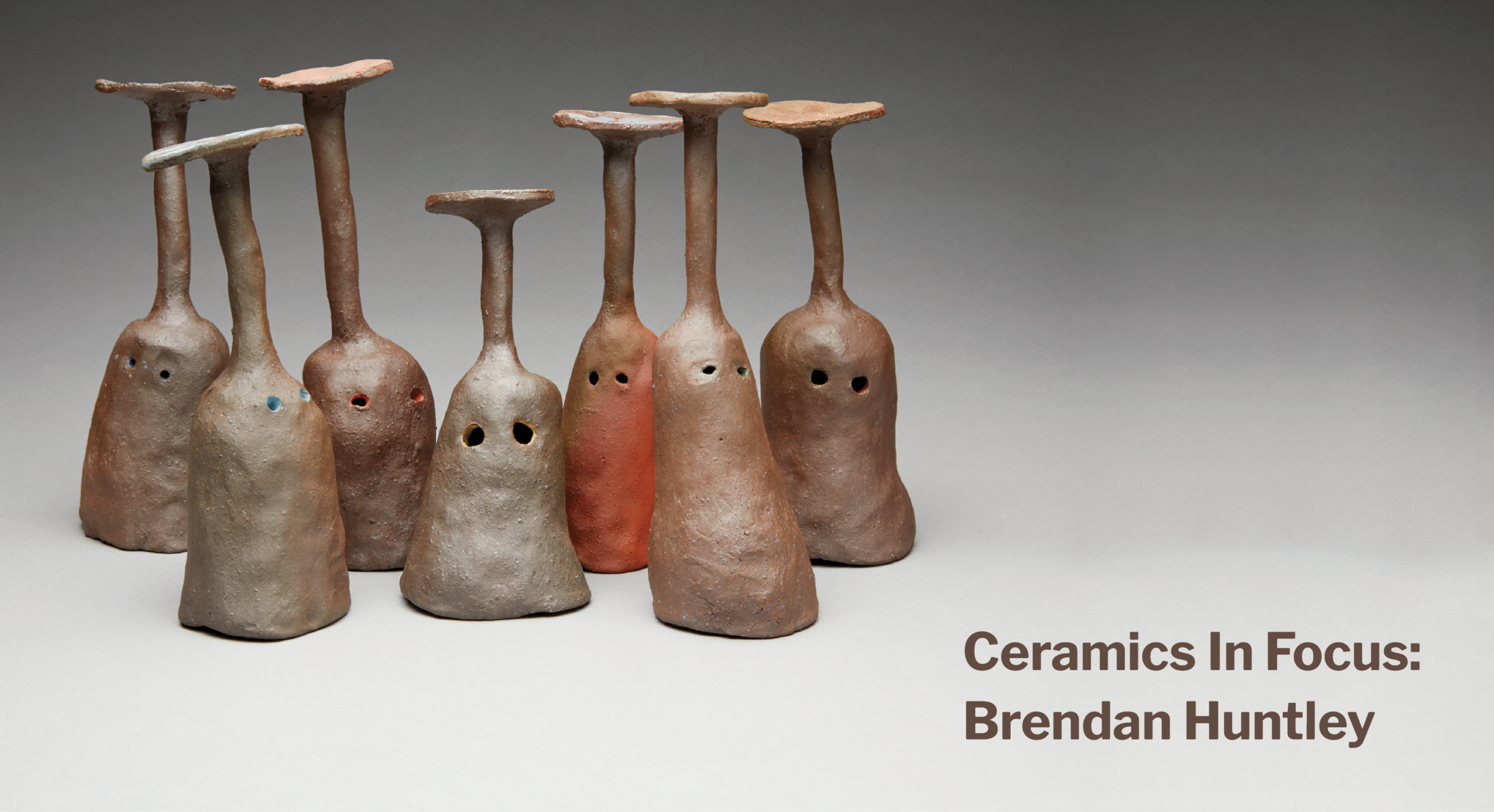 Banner image featuring seven brown ceramic goblets, each with a pair of eyes, positioned upside-down on a grey-gradient surface. Text to the right reads: Ceramics in Focus, Brendan Huntley